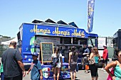 Customers in front of a food truck at a food truck festival in California, USA