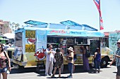 Customers in front of a Thai food truck at a food truck festival in California, USA