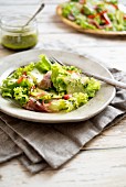 A mixed leaf salad with star fruits and ham