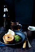 A meat pie with mashed potatoes and mushy peas (Great Britain)