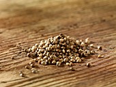 A pile of hemp seeds on a wooden surface