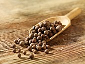 Allspice berries on a wooden scoop