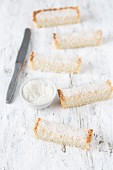 Slices of white coconut tart with grated coconut