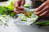 Vegan rice paper rolls with tofu and asparagus being made
