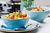 Vegan couscous salad with colourful fried vegetables and parsley