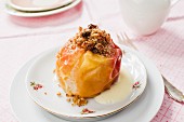 A baked apple with figs, nuts and vegan vanilla sauce