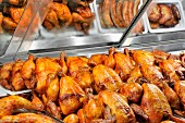 Grilled chicken and other grilled meats in a fast food display