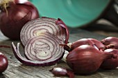 Large and small red onions, sliced on a chopping board
