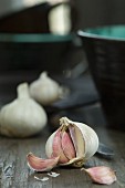 An open bulb of garlic on a wooden table