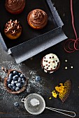 Chocolate cupcakes and blueberry tartlets