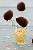 Chocolate lollies in a glass with sugar stars and hearts