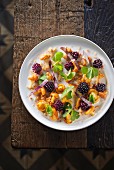 Chanterelle mushroom salad with blackberries (seen from above)