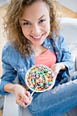 A young woman eating cereal