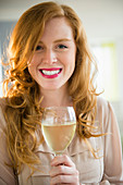An attractive woman holding a glass of wine
