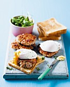 Sausage meat burgers on toast with poached eggs