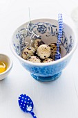 Quail eggs in a floral patterned bowl