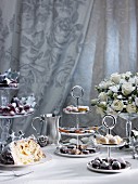 A table laid for Christmas and sugared grapes, Panettone, pralines and white roses