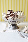 An ice cream sundae with white and dark chocolate drizzle