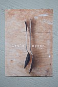 Message and vintage spoons on wooden board