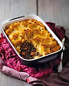 Ostrich pie with a pumpkin and potato topping