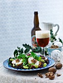 Winter salad with cheese and walnut crostini and grapes