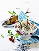 Potato salad with radishes served with smoked fish