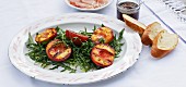 Grilled peaches with honey and chill on a bed of rocket