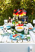 Table set for football-themed party in summery garden