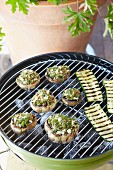 Grilled courgette slices and stuffed mushrooms with herbs and cheese