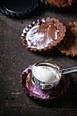 Homemade ice cream with frozen berries in chocolate tartlet bases