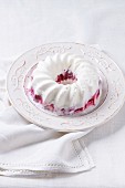 An ice cream cake with berries on a vintage plate