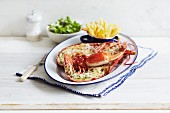 A halved lobster with chips and a side salad