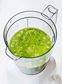 A green smoothie made from fresh fruit and leaves