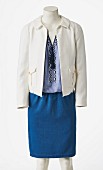 A blue skirt, a short white jacket and a light-blue ethnic blouse on a headless tailor's dummy