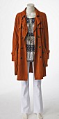 Brown leather coat and white trousers on mannequin without head