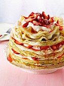 A pancake cake with strawberries and crème fraîche