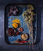 Dried herbs and spices on a blue tray