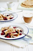 Pancakes with cherries and fruit sauce