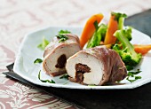 Chicken roulade wrapped in bacon and stuffed with dried fruit