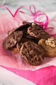 A pile of cookies on tissue paper with a pink ribbon