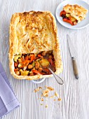Sausage, vegetable and kidney bean bake with a puff pastry topping
