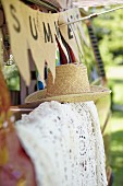 Summer atmosphere with garland, straw hat & lace blanket
