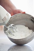 Egg whites being beaten with an electric whisk