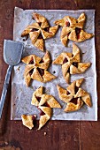 Raspberry jam pinwheel pastries on baking paper
