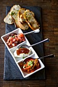 Bruschetta and ricotta with quince jam, Caprese and roasted red and yellow peppers with basil (Italy)