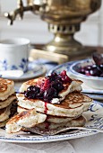 Blinis (honey-yeast pancakes, Russia) cherry compote and a samowar