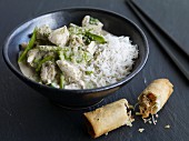 Green Thai chicken curry served with a vegetable spring roll