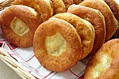 A basket of freshly baked Bauernkrapfen (Austrian yeast dough pastries)