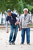 A young man and an old man playing Boule in Paris