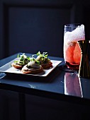 Toasts mit Jakobsmuschel-Tatar und Seeigelsauce und Ruby Crush Cocktail